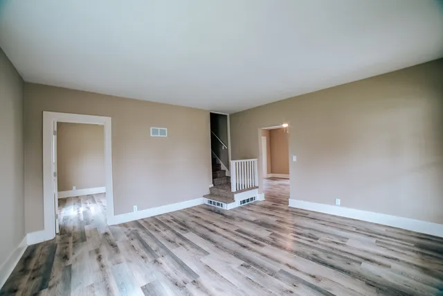 a view of a livingroom with wooden floor and closet