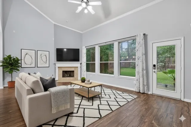 a living room with furniture a fireplace and a flat screen tv
