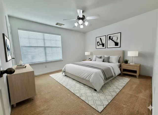 a bedroom with a large bed and a chandelier