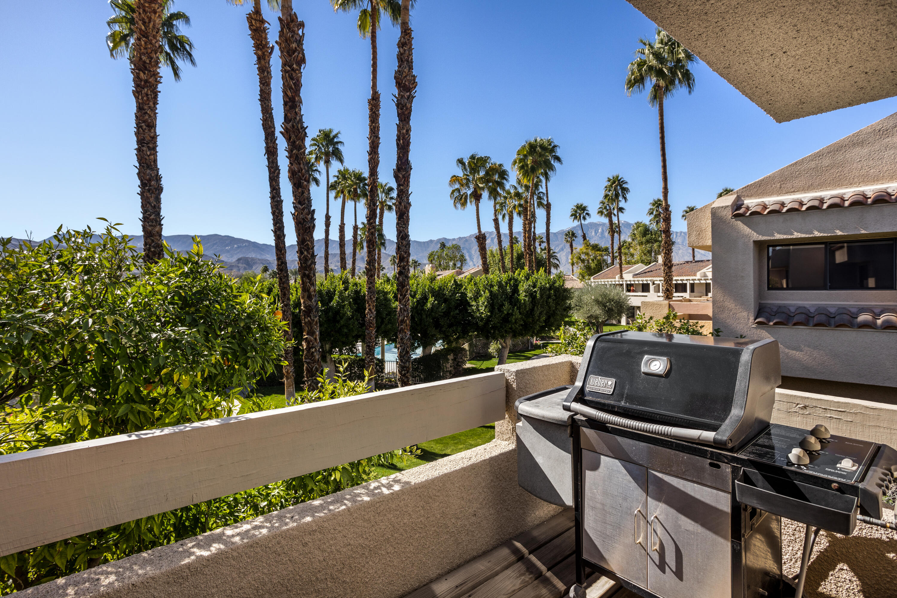11 Mission Court Rancho Mirage, CA 92270 - Photo 16 of 59 a view of a balcony with chairs and a potted plant