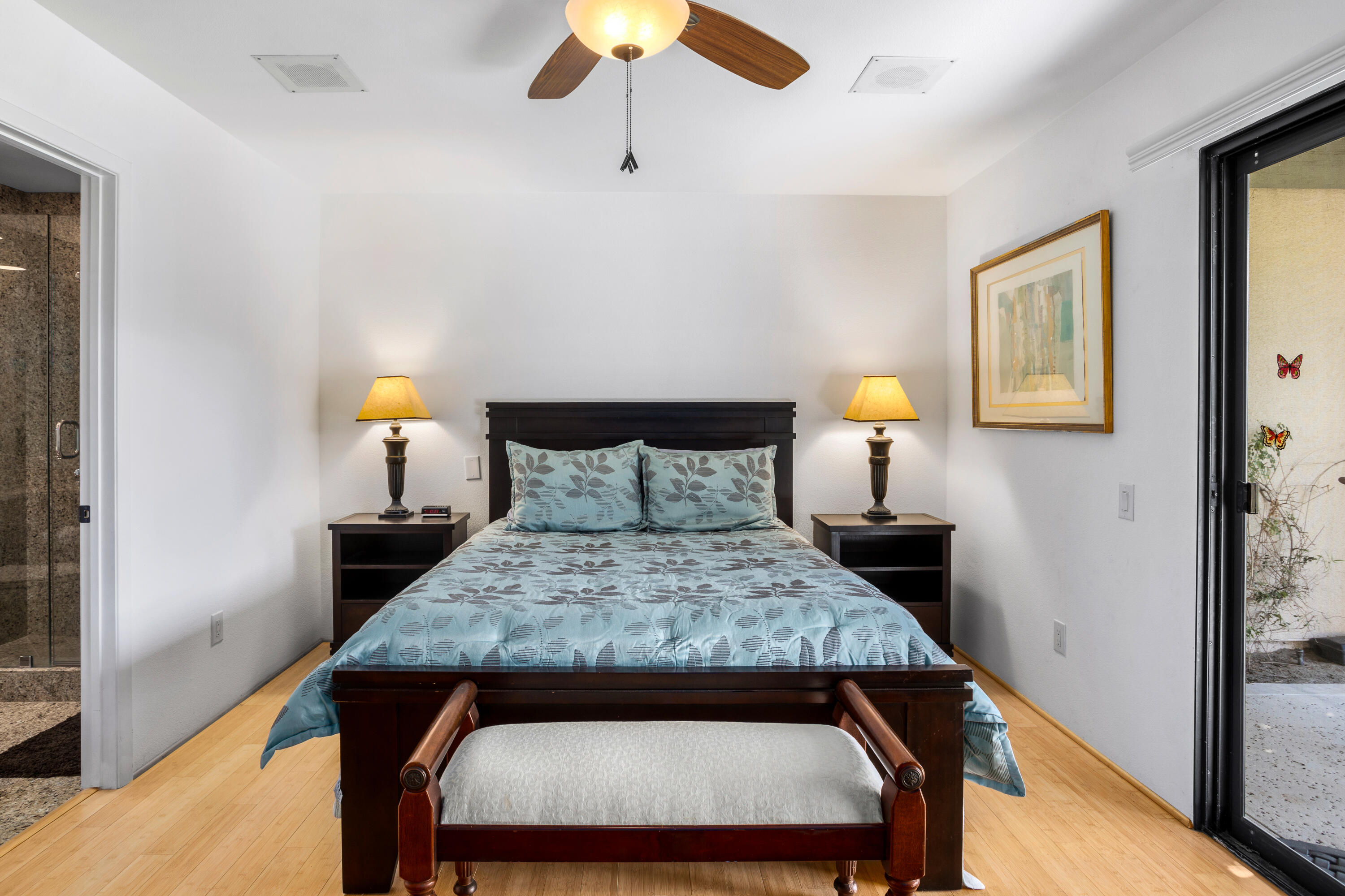 11 Mission Court Rancho Mirage, CA 92270 - Photo 26 of 59 a bed sitting in a bedroom next to a lamp