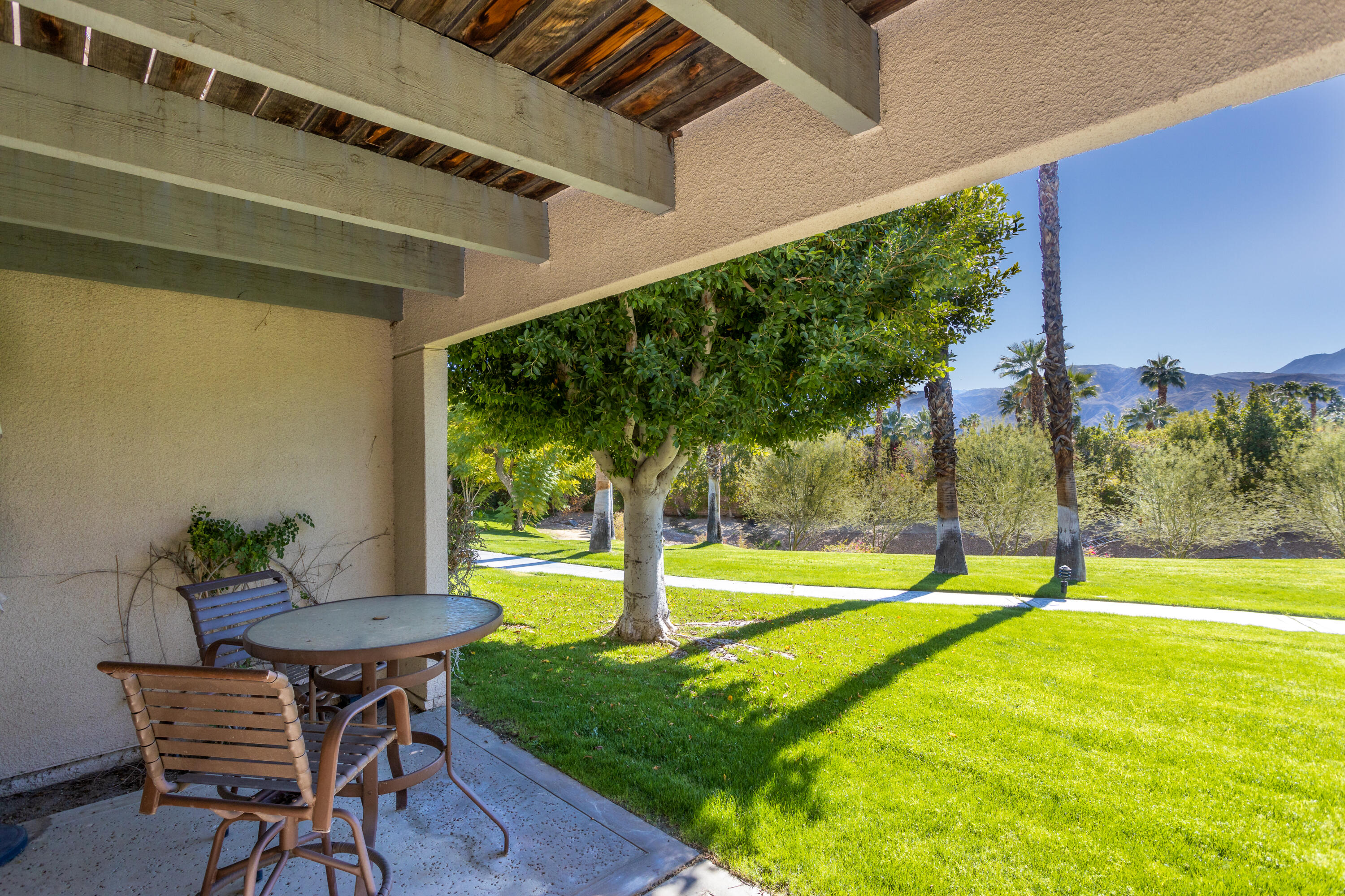 11 Mission Court Rancho Mirage, CA 92270 - Photo 30 of 59 a view of a backyard with table and chairs and potted plants