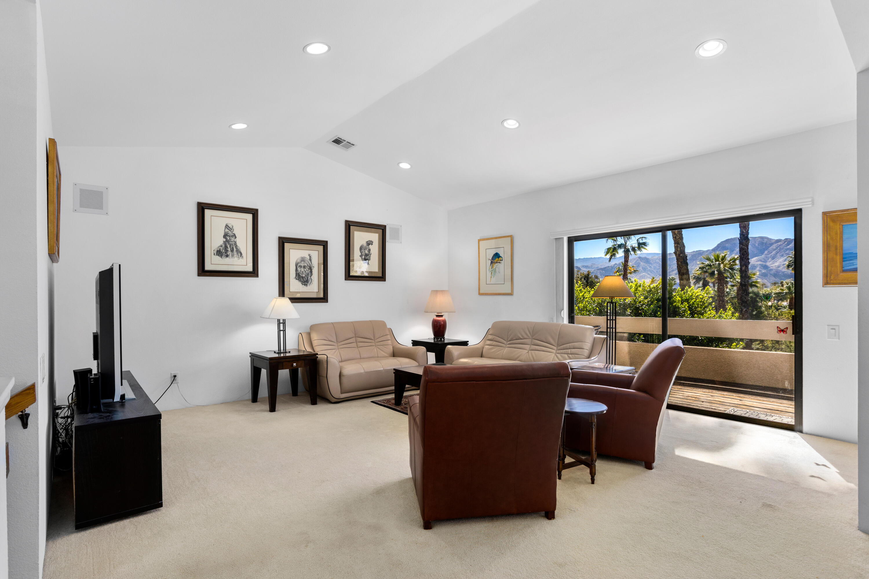 11 Mission Court Rancho Mirage, CA 92270 - Photo 3 of 59 a living room with furniture a large window and a flat screen tv