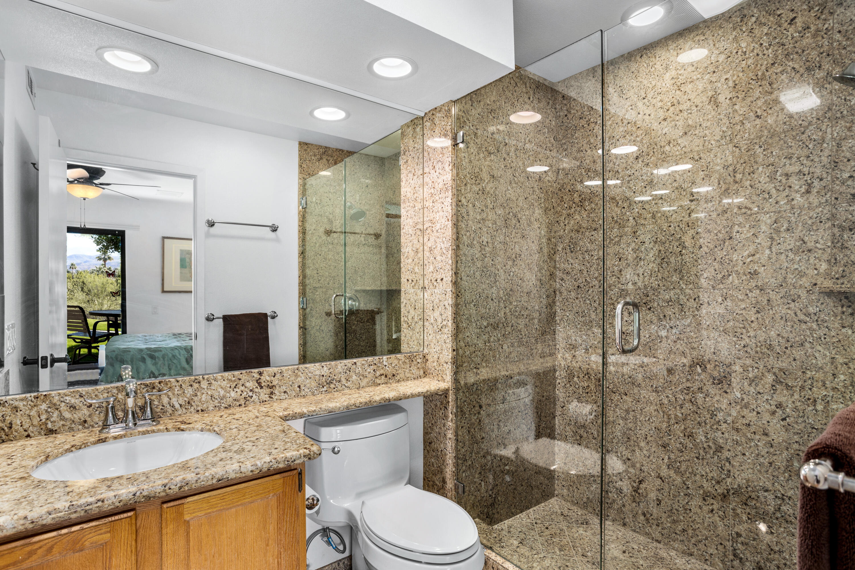 11 Mission Court Rancho Mirage, CA 92270 - Photo 31 of 59 a bathroom with a granite countertop sink toilet and shower