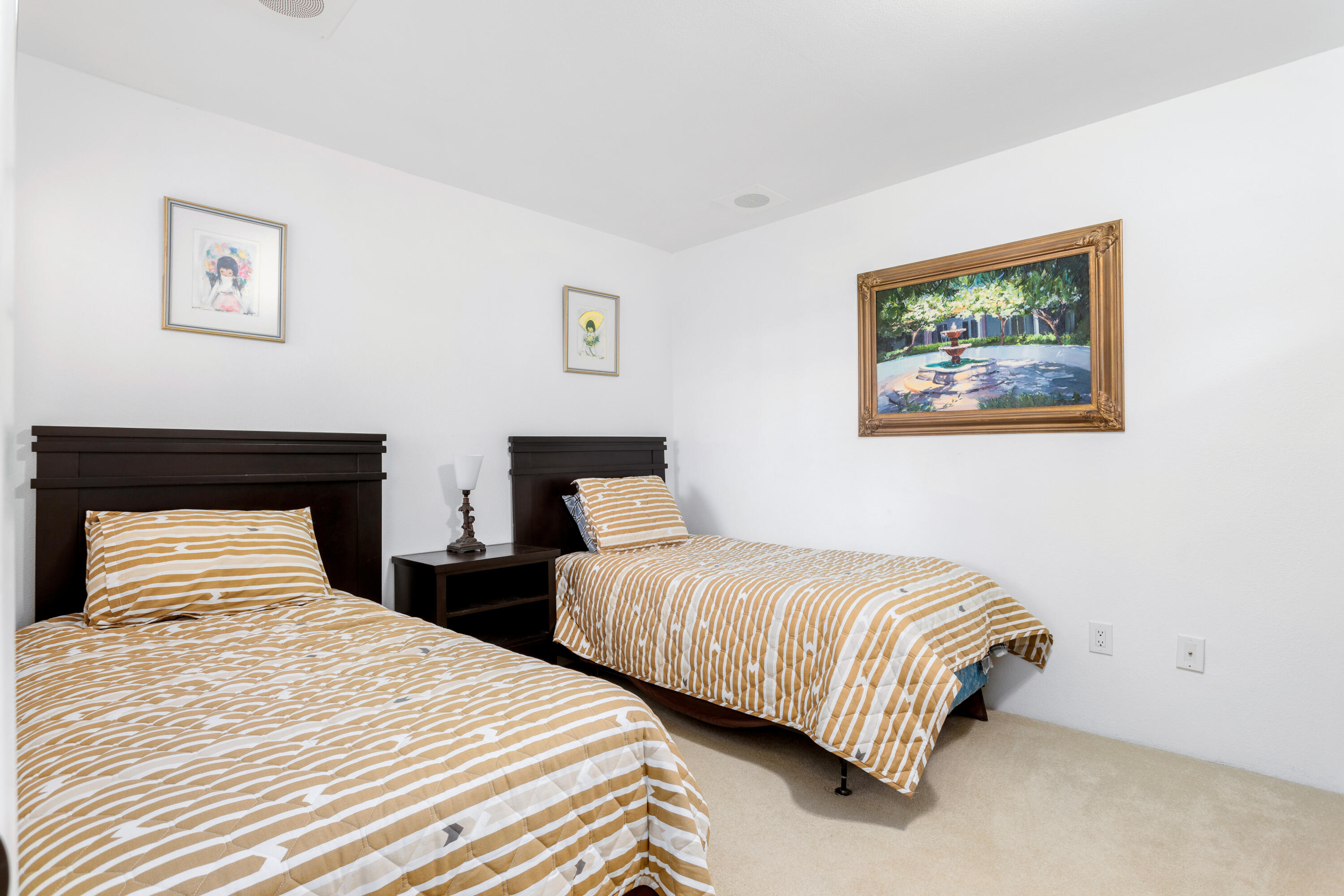 11 Mission Court Rancho Mirage, CA 92270 - Photo 39 of 59 a bedroom with two beds and painting on the wall