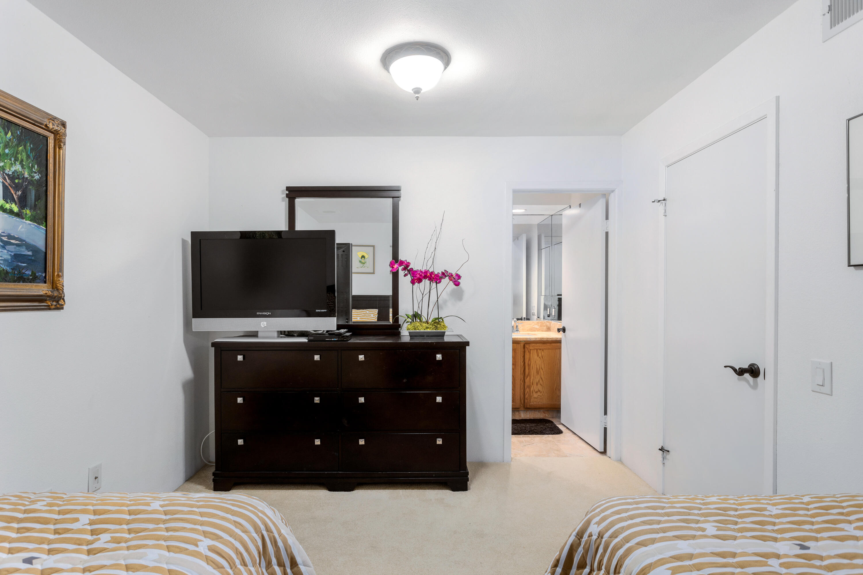 11 Mission Court Rancho Mirage, CA 92270 - Photo 40 of 59 a bedroom with a bed and flat screen tv