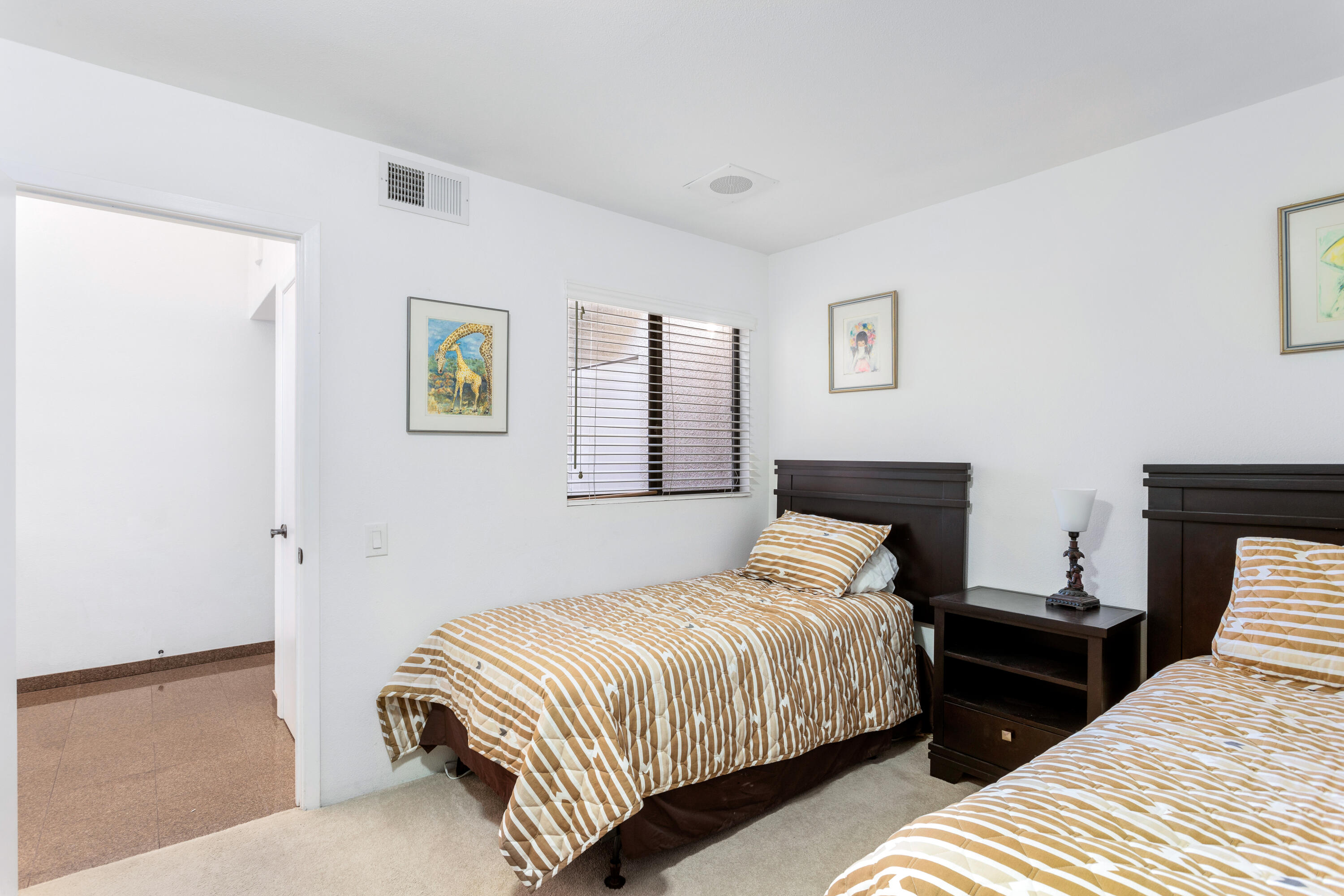 11 Mission Court Rancho Mirage, CA 92270 - Photo 41 of 59 a bedroom with two beds and painting on the wall