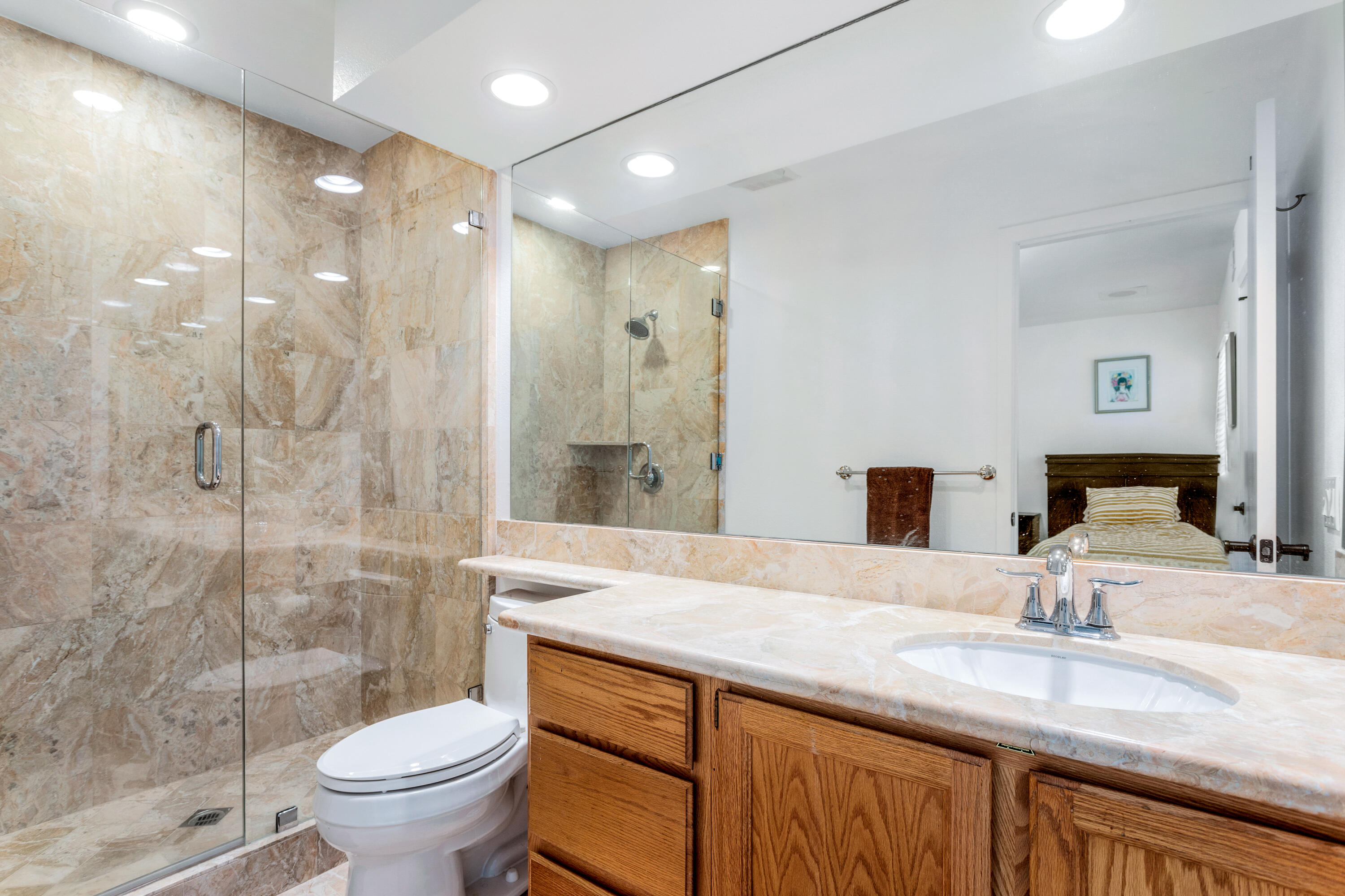11 Mission Court Rancho Mirage, CA 92270 - Photo 42 of 59 a bathroom with a granite countertop sink a toilet and shower