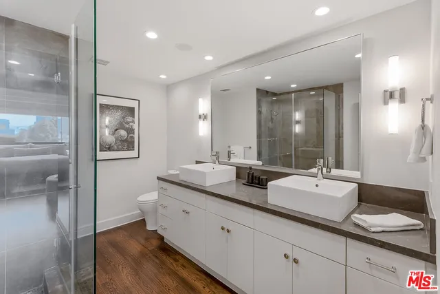 a bathroom with double vanity sinks double vanity and a shower