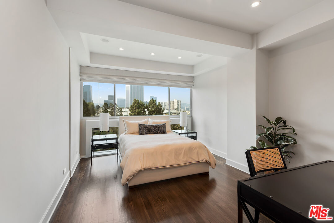 2220 Avenue Of The Stars, Unit 702 Los Angeles, CA 90067 - Photo 12 of 21 a bedroom with a bed and wooden floor