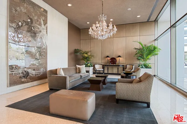 a living room with patio furniture and a chandelier