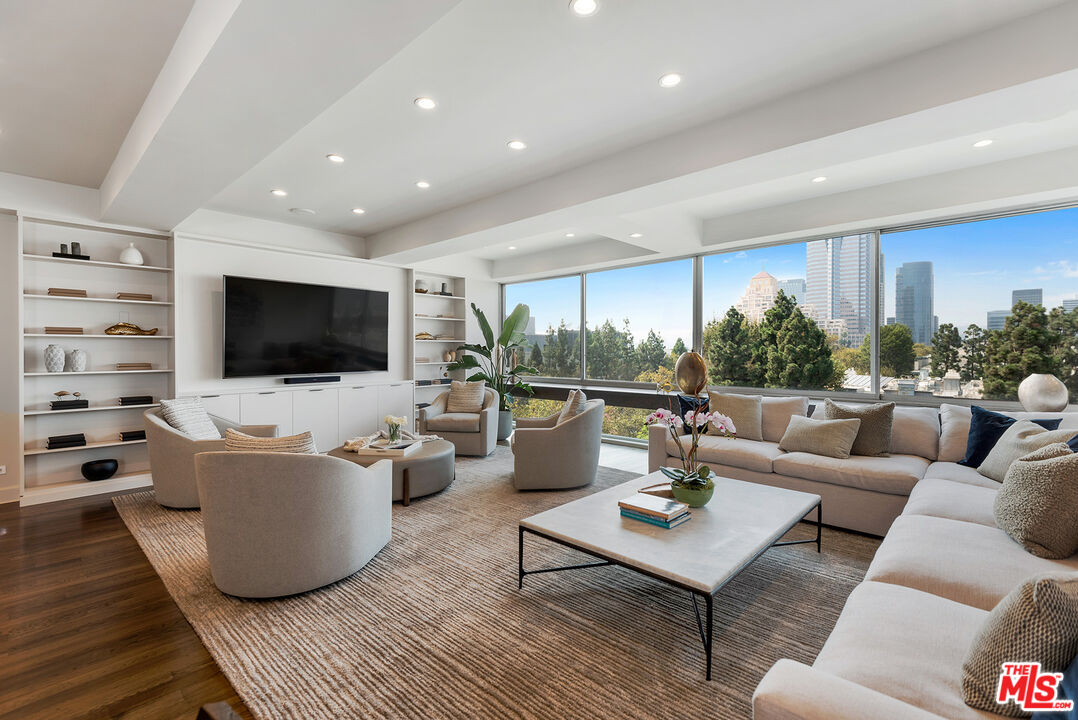2220 Avenue Of The Stars, Unit 702 Los Angeles, CA 90067 - Photo 2 of 21 a living room with furniture and a flat screen tv
