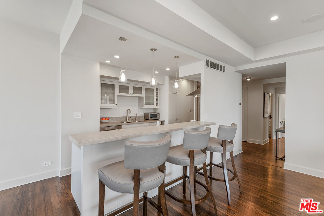 2220 Avenue Of The Stars, Unit 702 Los Angeles, CA 90067 - Photo 5 of 21 a kitchen with a dining table chairs and wooden floor
