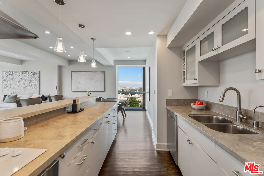 2220 Avenue Of The Stars, Unit 702 Los Angeles, CA 90067 - Photo 7 of 21 a kitchen with counter top a sink cabinets and appliances