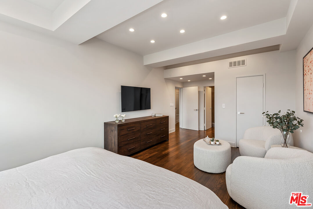 2220 Avenue Of The Stars, Unit 702 Los Angeles, CA 90067 - Photo 10 of 21 a bedroom with a bed and a flat screen tv