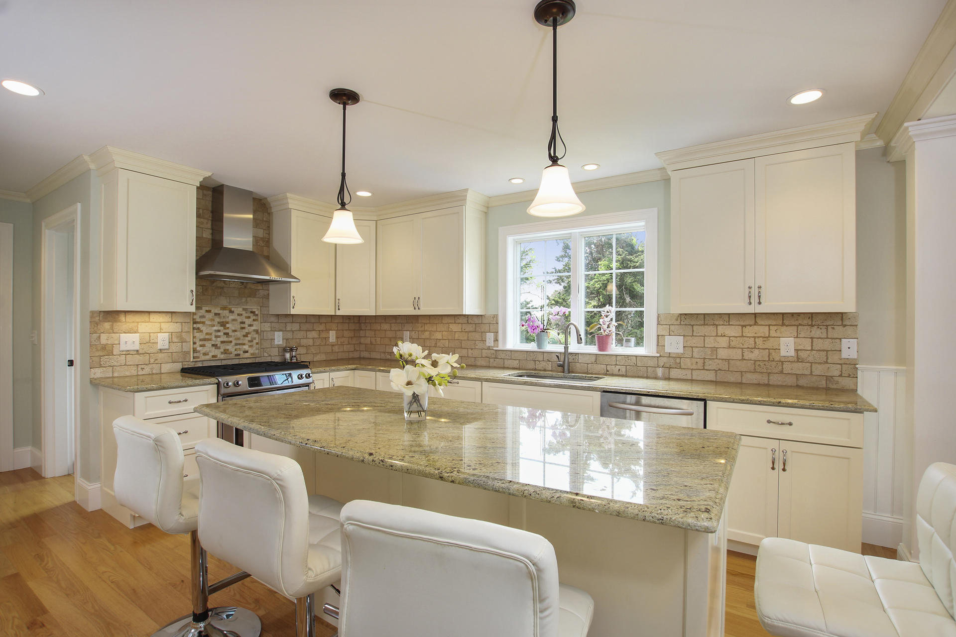 47 Briar Spring Road Orleans, MA 02653 - Photo 10 of 30 a kitchen with a stove a sink a window and chairs