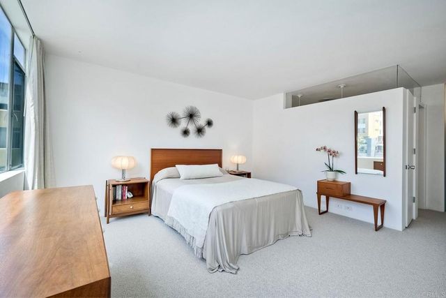 a bedroom with a bed and window