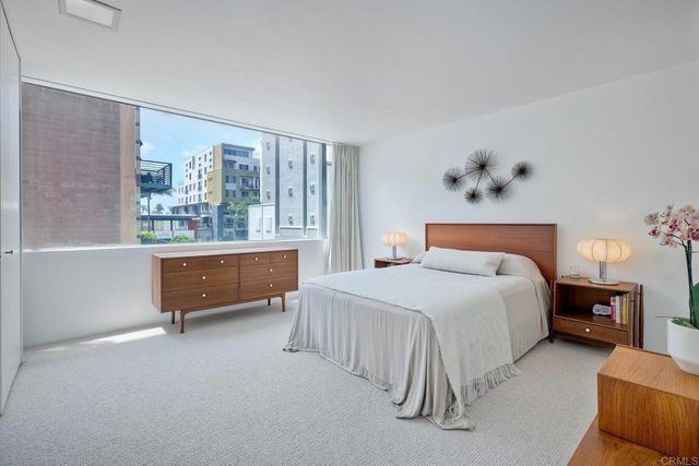 a bedroom with a bed and a window