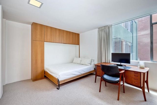 a bedroom with a bed and a desk