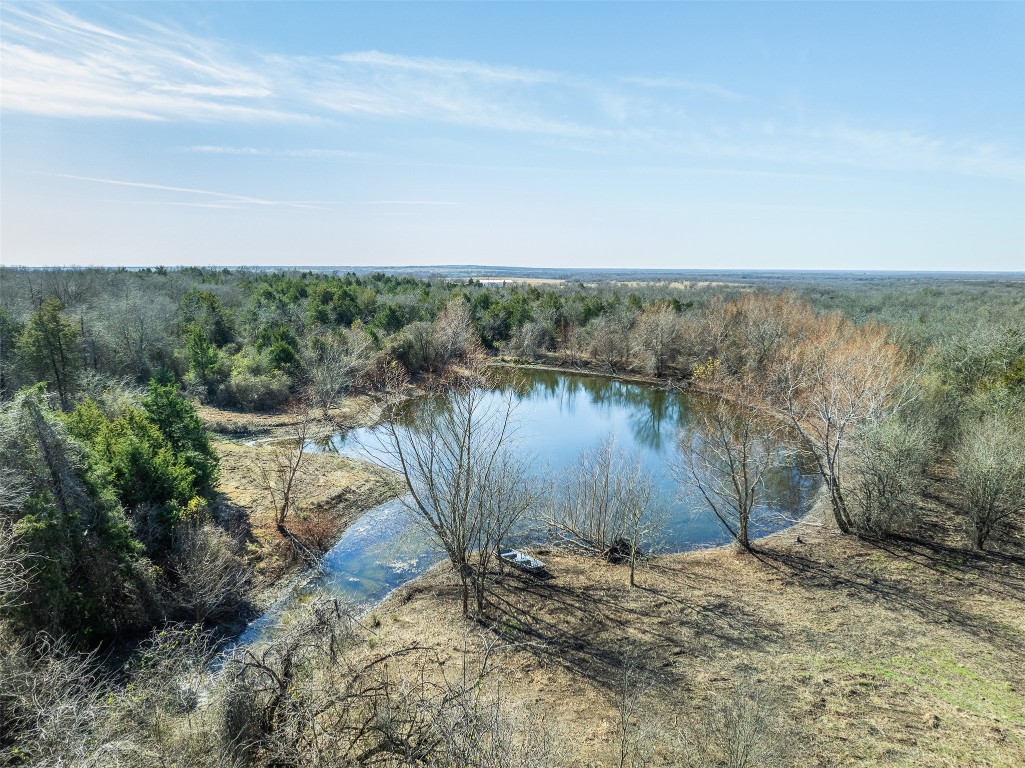 5 County Road 386 Groesbeck, TX 76642 - Photo 1 of 19 a view of a lake with a mountain in the background