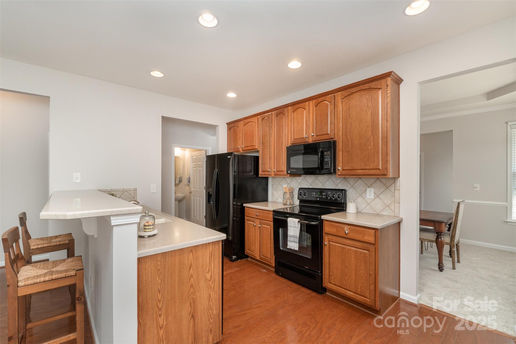 620 Amethyst Circle Fort Mill, SC 29708 - Photo 15 of 32 a kitchen with stainless steel appliances a microwave a stove a sink a refrigerator and chairs