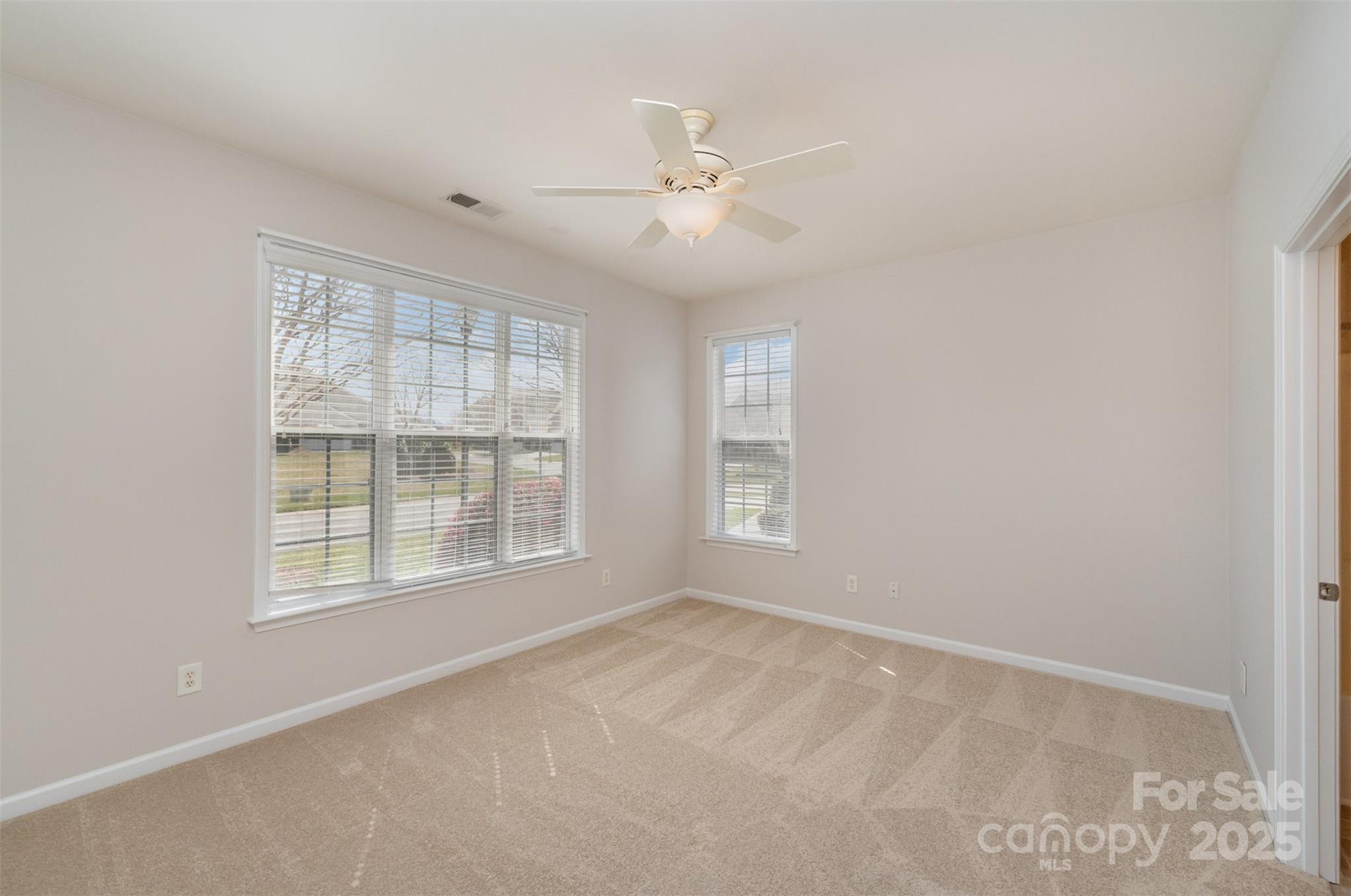 620 Amethyst Circle Fort Mill, SC 29708 - Photo 24 of 32 an empty room with chandelier fan and windows
