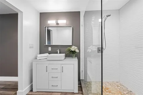 a bathroom with a sink a vanity and a mirror