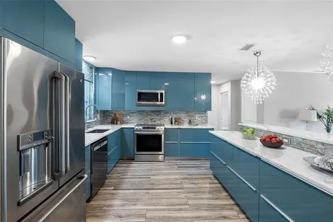 a large kitchen with granite countertop a lot of counter top space