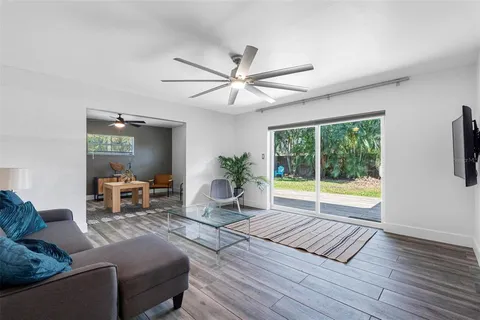 a living room with furniture and wooden floor