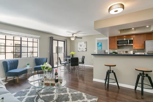 a living room with furniture and wooden floor