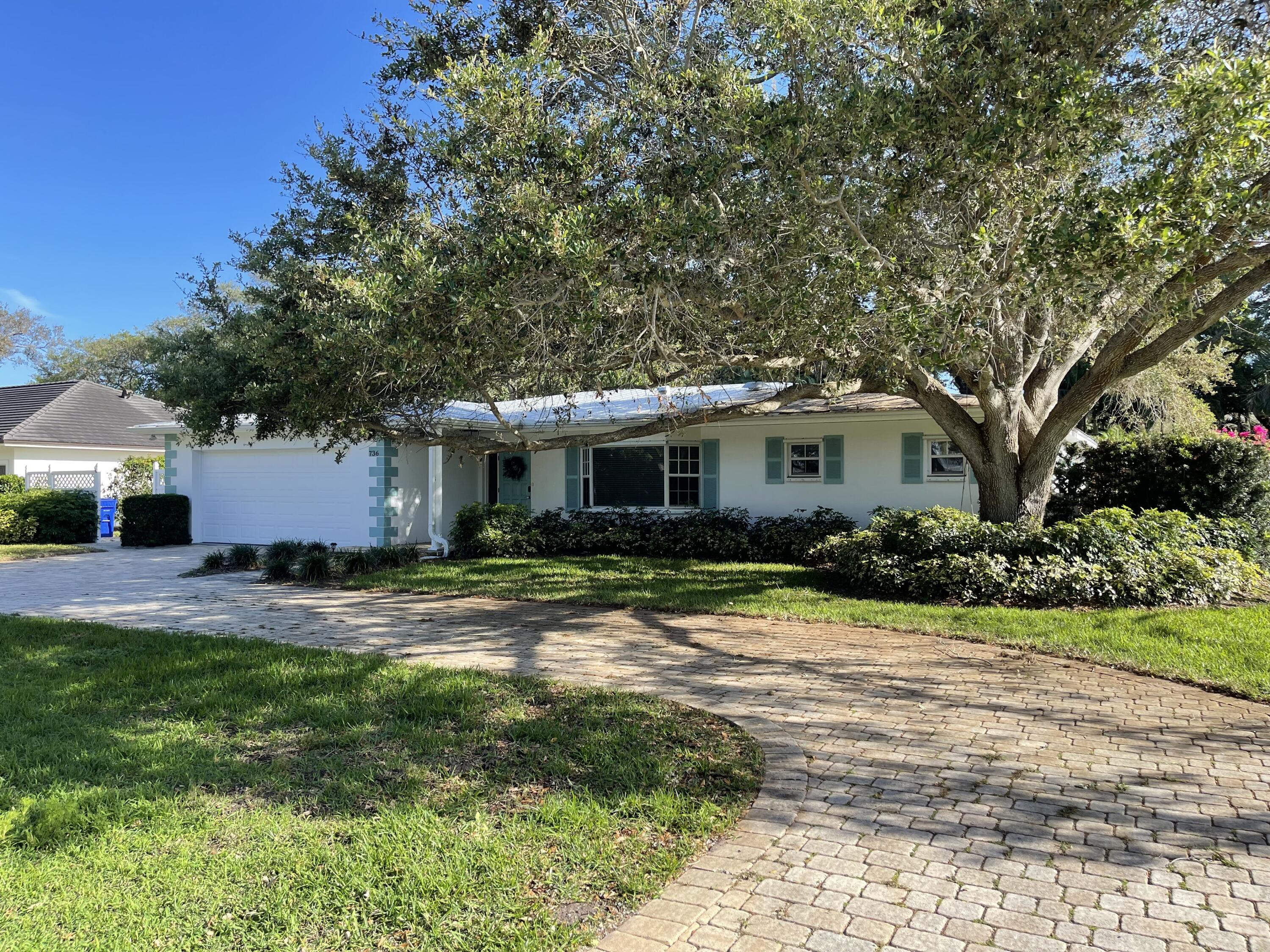 736 Iris Lane Vero Beach, FL 32963 - Photo 1 of 54 a front view of a house with a yard and garage