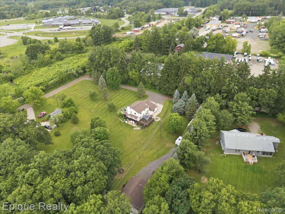 1221 Rhodes Road Lake Orion, MI 48360 - Photo 64 of 72 Expansive property featuring a two-story residence with a multi-level deck and surrounding green space