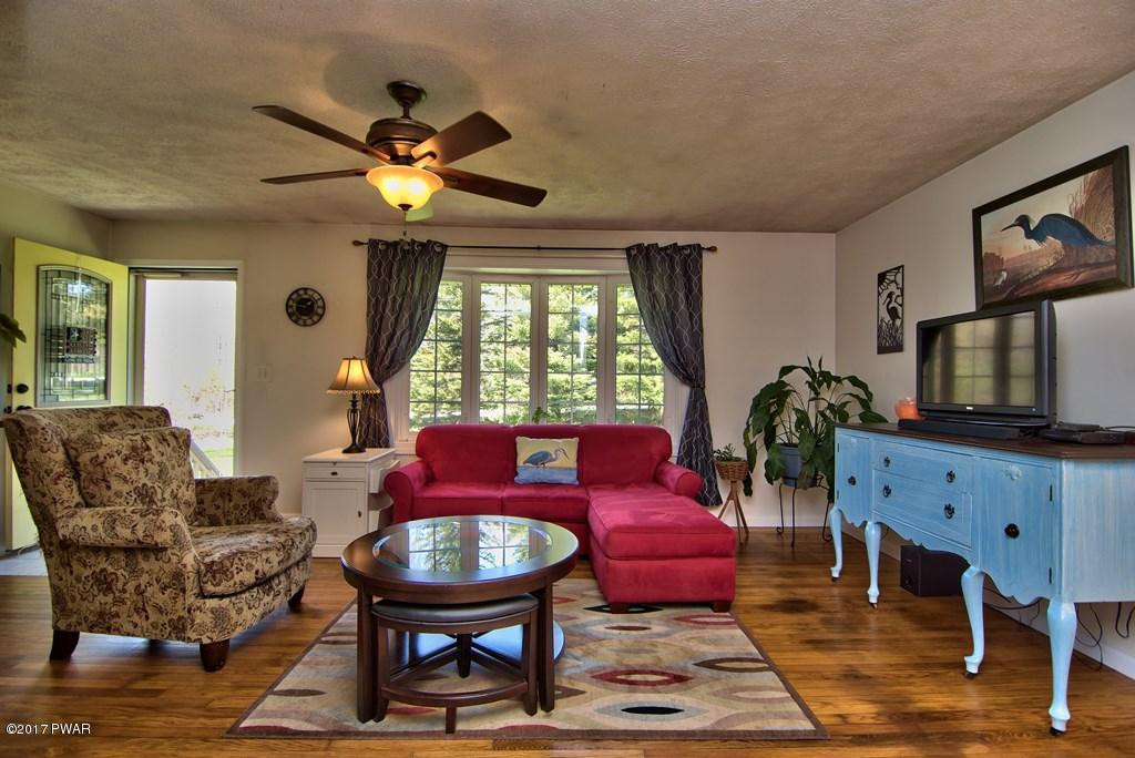 1058 Rosengrant Road Lake Ariel, PA 18436 - Photo 5 of 47 a living room with furniture a window and a flat screen tv