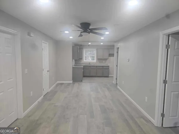 a view of a kitchen with a sink and a refrigerator