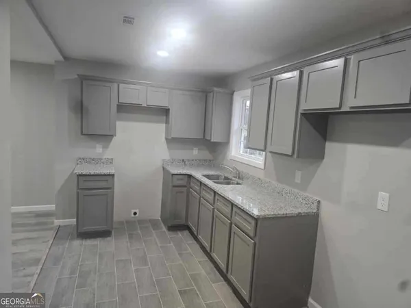 a kitchen that has a sink and a stove in it