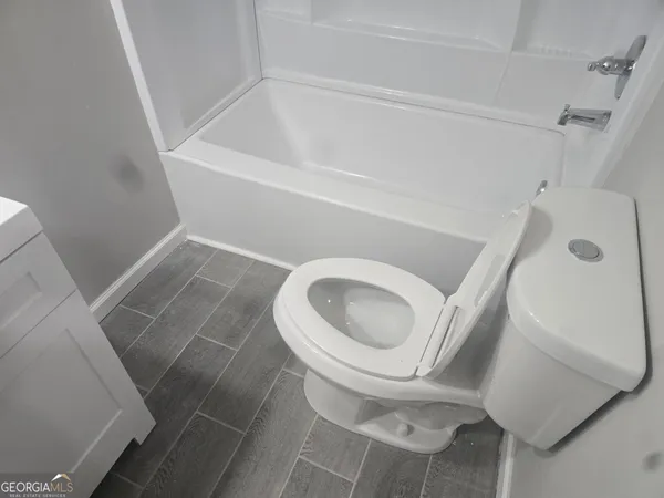 a bathroom with a toilet and a sink