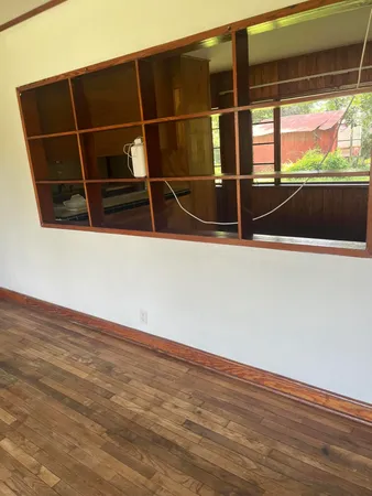 a view of walk in closet with wooden floor