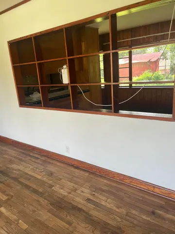 a view of walk in closet with wooden floor