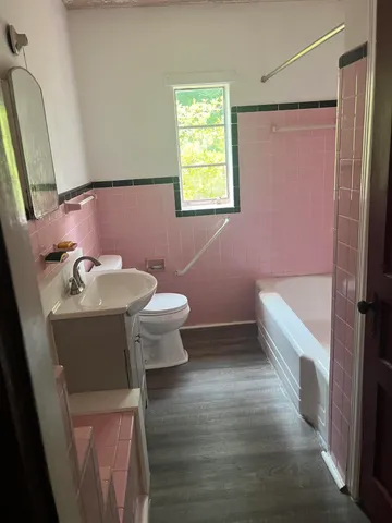 a bathroom with a sink toilet and shower