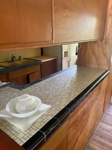 a view of a kitchen counter top and living room