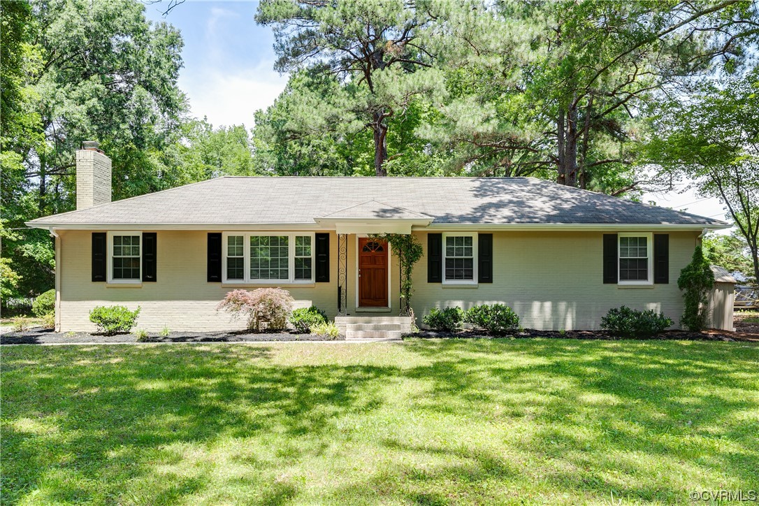 a front view of a house with a garden and porch