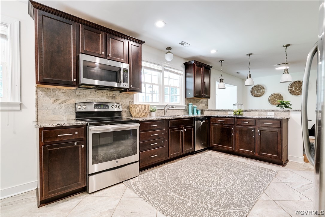 4061 Old Gun Road East Midlothian, VA 23113 - Photo 13 of 42 a kitchen with a stove and a microwave