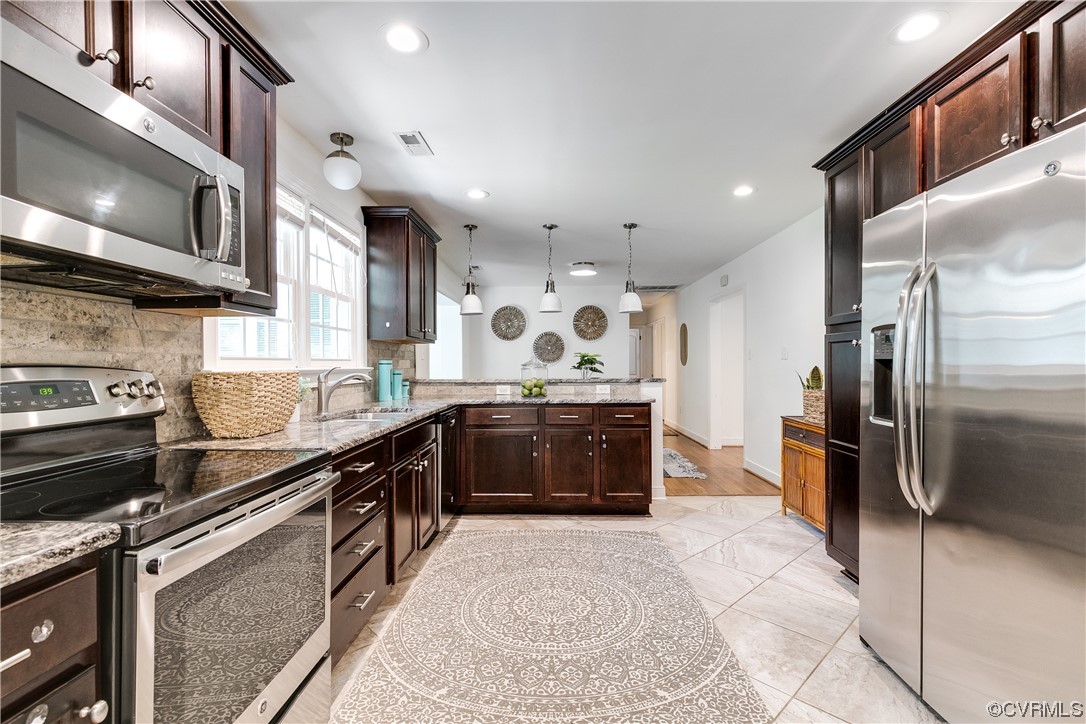 4061 Old Gun Road East Midlothian, VA 23113 - Photo 14 of 42 a kitchen with stainless steel appliances granite countertop a stove a sink and a refrigerator