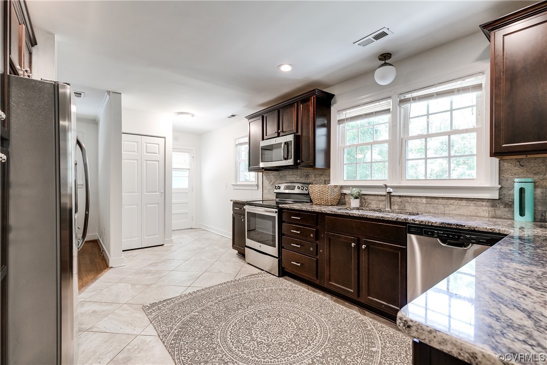 4061 Old Gun Road East Midlothian, VA 23113 - Photo 17 of 42 a kitchen with stainless steel appliances granite countertop a refrigerator stove top oven and sink