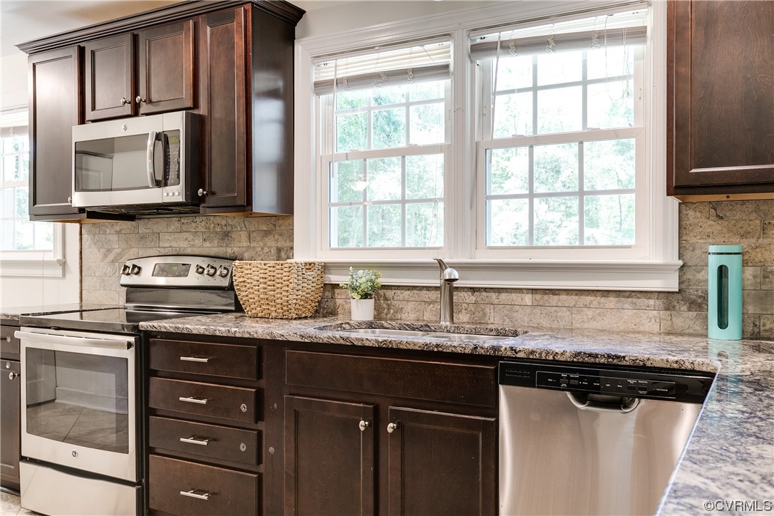 4061 Old Gun Road East Midlothian, VA 23113 - Photo 18 of 42 a kitchen with granite countertop cabinets stainless steel appliances a sink and a window