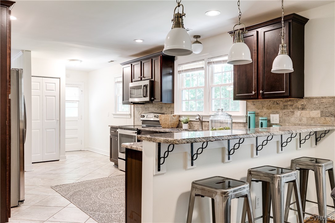 4061 Old Gun Road East Midlothian, VA 23113 - Photo 19 of 42 a view of kitchen with stainless steel appliances kitchen island granite countertop a sink and cabinets