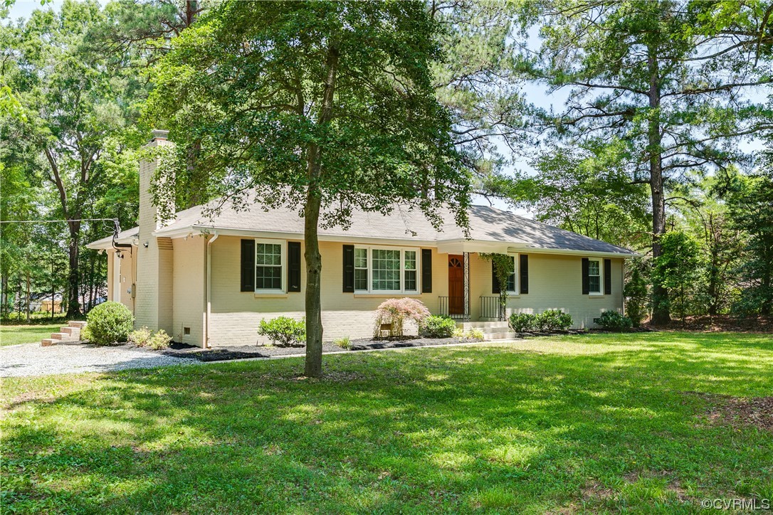 4061 Old Gun Road East Midlothian, VA 23113 - Photo 2 of 42 a front view of house with a garden and trees