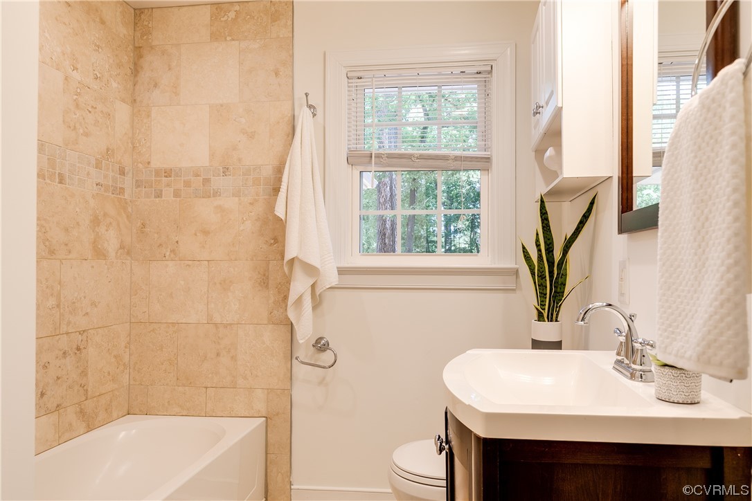 4061 Old Gun Road East Midlothian, VA 23113 - Photo 27 of 42 a bathroom with a sink a toilet and shower