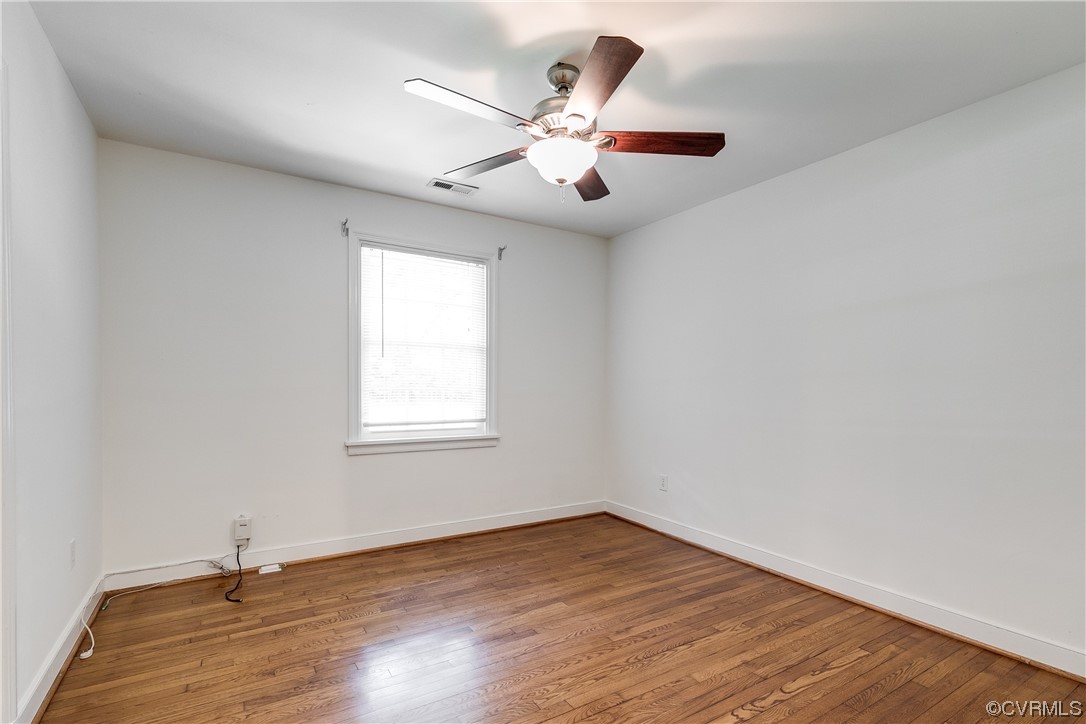 4061 Old Gun Road East Midlothian, VA 23113 - Photo 28 of 42 an empty room with wooden floor fan and windows