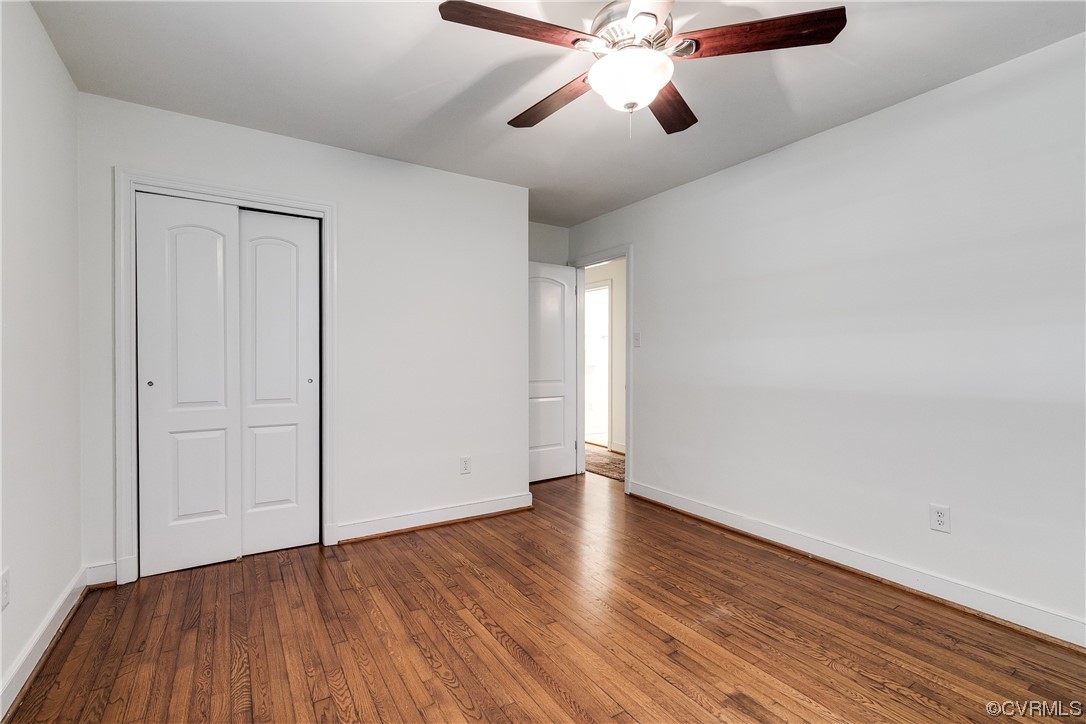4061 Old Gun Road East Midlothian, VA 23113 - Photo 29 of 42 an empty room with wooden floor chandelier fan and windows